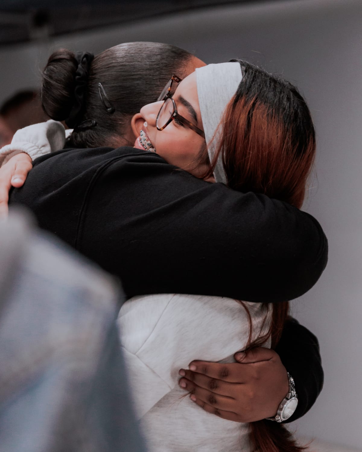 People embracing in community at NBCFC