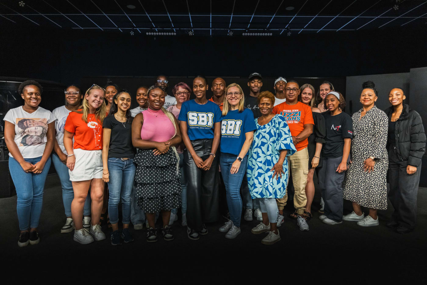 Group of 2025 SBI graduates celebrating together on the church steps