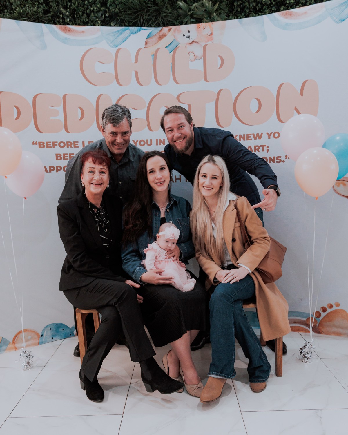 Family celebrating child dedication at NBCFC