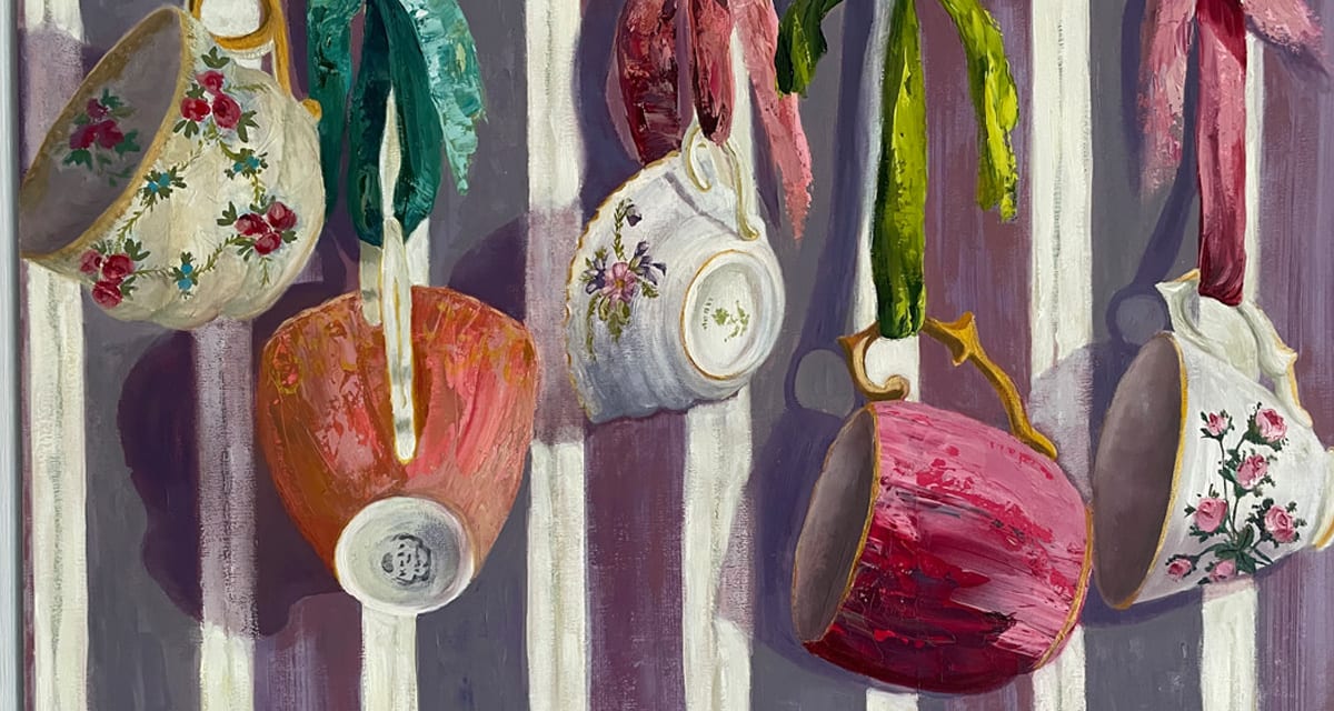 'The Ribbons Took Her Back to Childhood' is a medium sized oil painting featuring antique tea cups hung on ribbons in pinks and white against a striped mauve background.