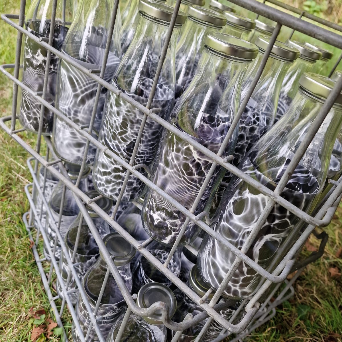 'Belief', alternative cameraless photography, installation of crates of cameraless watergram b/w ripple images of sacred spring water, in glass bottles, by Paeony Lewis