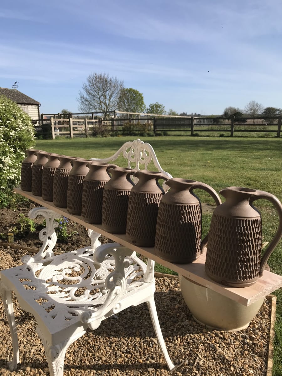 Carved stoneware jugs by Kat Wheeler