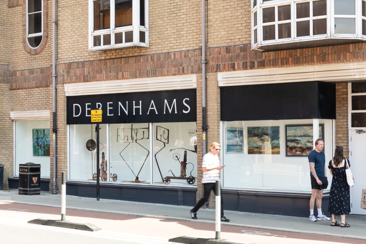 The Old Debenhams building on Head Street, Colchester, with Colchester Art Society artworks installed in its disused shop windows.