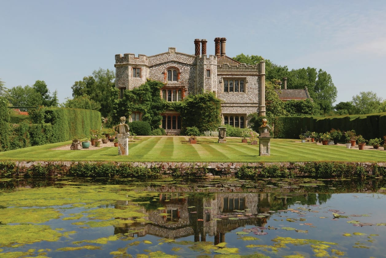 Mannington Hall seen across the moat from the garden