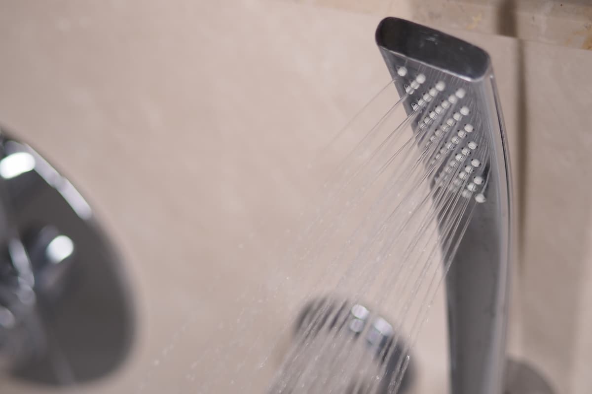 Modern shower system with rainfall head and digital controls in a contemporary London bathroom
