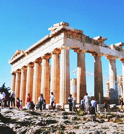 The Parthenon ancient Greek temple on the Acropolis in Athens with tourists visiting the iconic marble columns and ruins