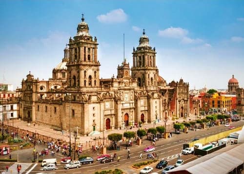 Mexico City Metropolitan Cathedral with twin towers and main plaza, historic colonial architecture and city streets below