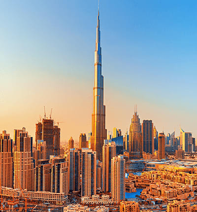 Burj Khalifa and Dubai skyline at sunset with surrounding skyscrapers and cityscape
