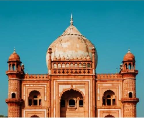 Safdarjung's Tomb in Delhi with terracotta red sandstone architecture and white marble dome against clear blue sky