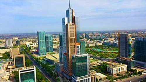 Aerial view of Tashkent skyline showing tall modern buildings and Main Bazaar area with green spaces