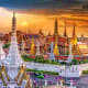 Grand Palace and Temple of the Emerald Buddha at sunset in Bangkok, Thailand, with golden spires and ornate traditional archi