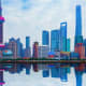 Shanghai skyline featuring Oriental Pearl Tower and modern skyscrapers reflected in water
