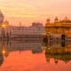 Golden Temple at sunrise reflected in the sacred pool, Amritsar India