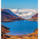 Mountain lake surrounded by rocky peaks with white clouds above, Gangtok region landscape