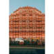 Hawa Mahal palace with pink terracotta facade and small arched windows in Jaipur, India