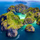 Aerial view of limestone islands with turquoise lagoon in Krabi, Thailand surrounded by blue sea