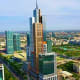 Aerial view of Tashkent skyline with modern skyscrapers and the prominent central tower under blue sky