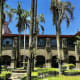 Historic Spanish colonial courtyard with palm trees and stone architecture in Manila, Philippines