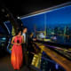 Couple in formal attire viewing Singapore skyline and Marina Bay from Singapore Flyer observation deck at night