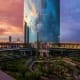 Riyadh cityscape at sunset with modern skyscrapers, bridge, and landscaped gardens overlooking urban skyline