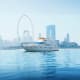 Luxury yacht anchored in Dubai waters with Ferris wheel and city skyline in background