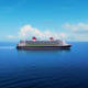 Disney cruise ship sailing on calm blue ocean water under clear sky with white clouds