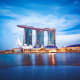 Marina Bay Sands hotel and casino illuminated at dusk reflected in calm water, Singapore skyline