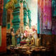 Historic Jeddah street scene with colorful traditional buildings, hanging fabrics, and locals in traditional dress shopping i