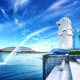 Merlion statue overlooking Marina Bay with modern buildings and blue sky in Singapore