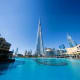 Burj Khalifa and Dubai skyline reflected in turquoise water of Burj Lake during daytime