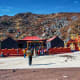 Buddhist monastery with red and black architecture nestled in rocky Himalayan foothills, Sikkim