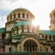 Alexander Nevsky Cathedral in Sofia, Bulgaria with golden domes and turquoise copper roofs against cloudy sky