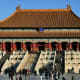 Palace of Heavenly Purity in the Forbidden City, Beijing, with golden glazed tile roofs and red walls under clear blue sky