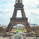 Eiffel Tower in Paris with Champ de Mars gardens and city skyline visible through the iron lattice structure