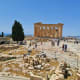 Ancient Greek ruins of the Parthenon temple with tourists exploring the archaeological site in Athens