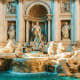 Trevi Fountain in Rome with baroque sculptures and turquoise water, featuring central Neptune statue and classical architectu