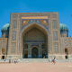 Registan square in Samarkand, Uzbekistan, featuring ornate tilework and towering minarets against blue sky