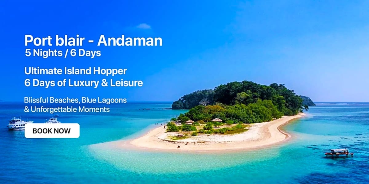 Tropical island in the Andaman Sea with white sandy beach, turquoise water, lush green vegetation, and traditional boats