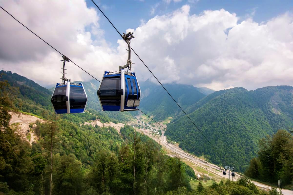 Cable car cabins suspended above forested mountain valley in Gabala, Azerbaijan