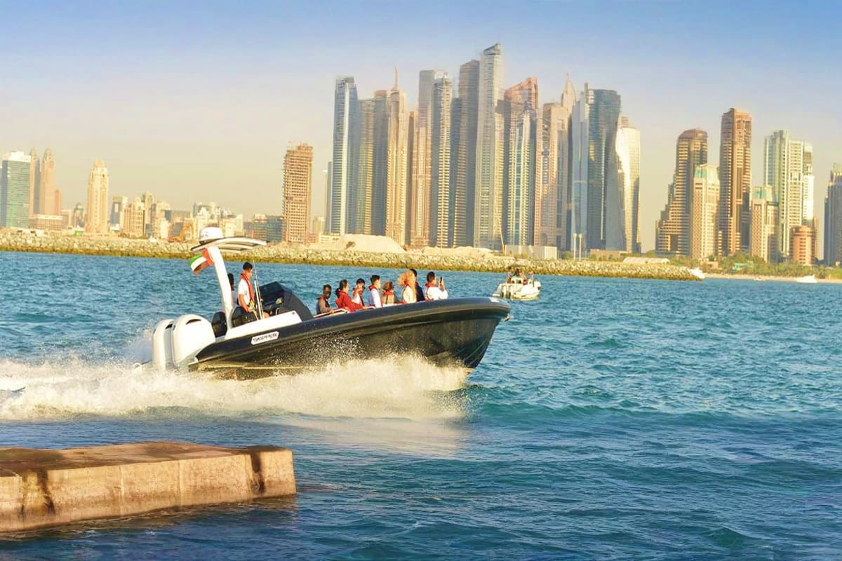 Black Boat Tours Black speedboat with tourists riding through waves near beach with Chicago skyline in background