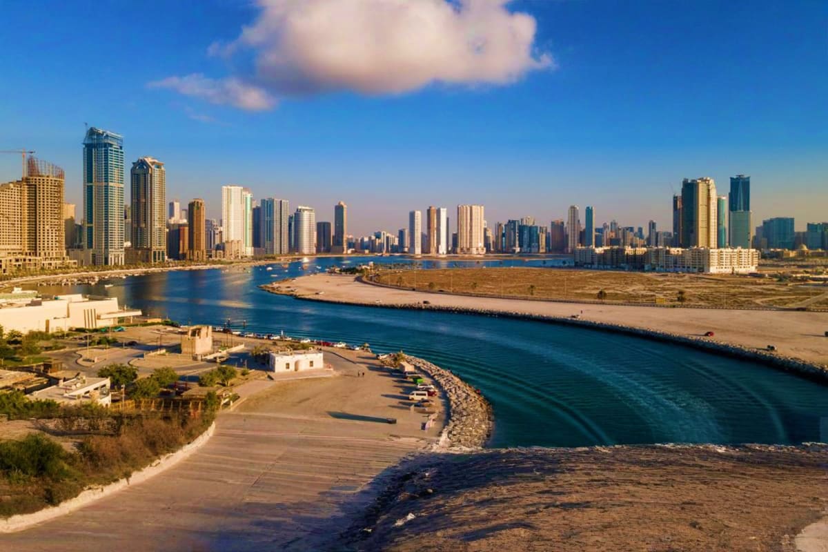 San Diego waterfront skyline with high-rise buildings, bay, and sandy beach during daytime
