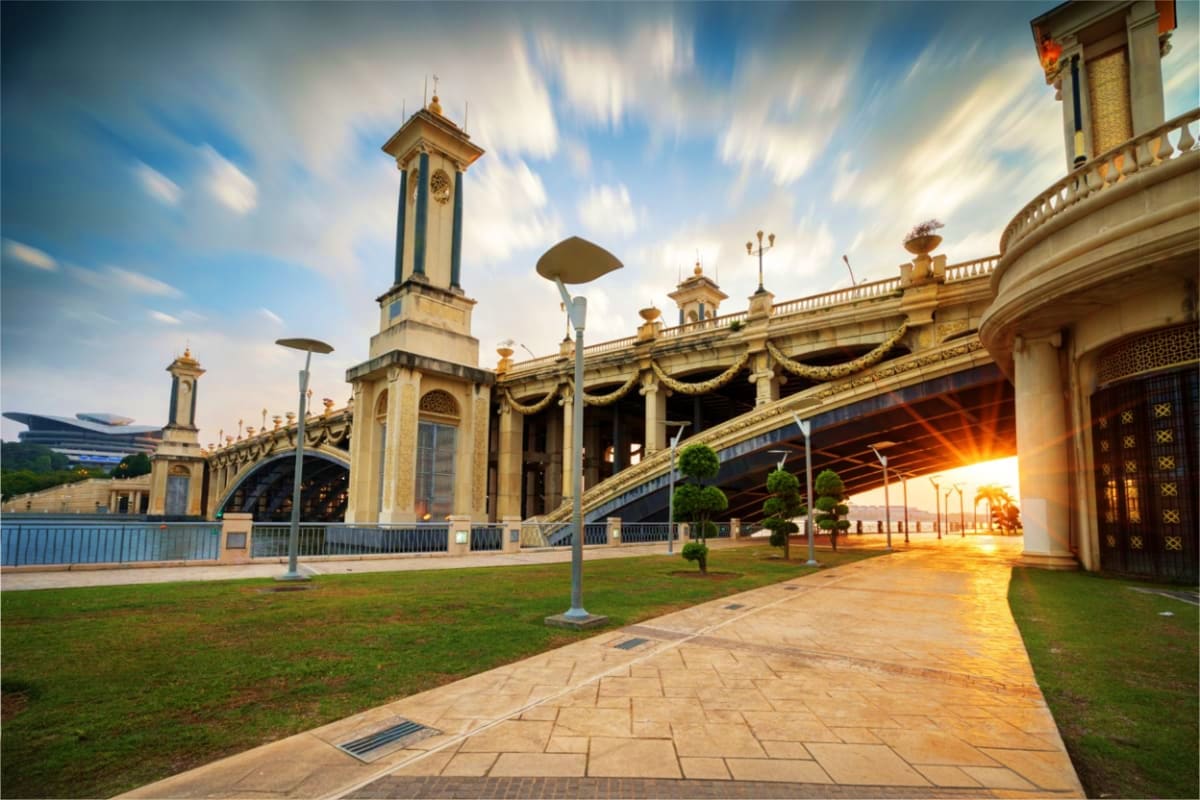 Masjid Putra mosque in Putrajaya with distinctive architecture, golden domes, and manicured lawns at sunset