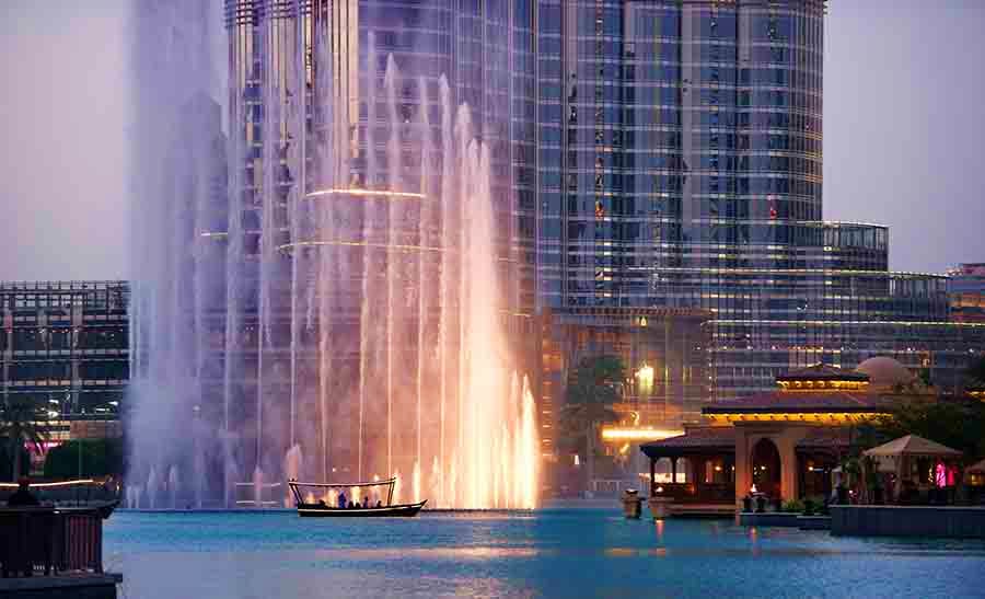 Dubai Fountain Lake Ride from Abu Dhabi Illuminated Dubai Fountain with boat ride at dusk, downtown skyscrapers in background