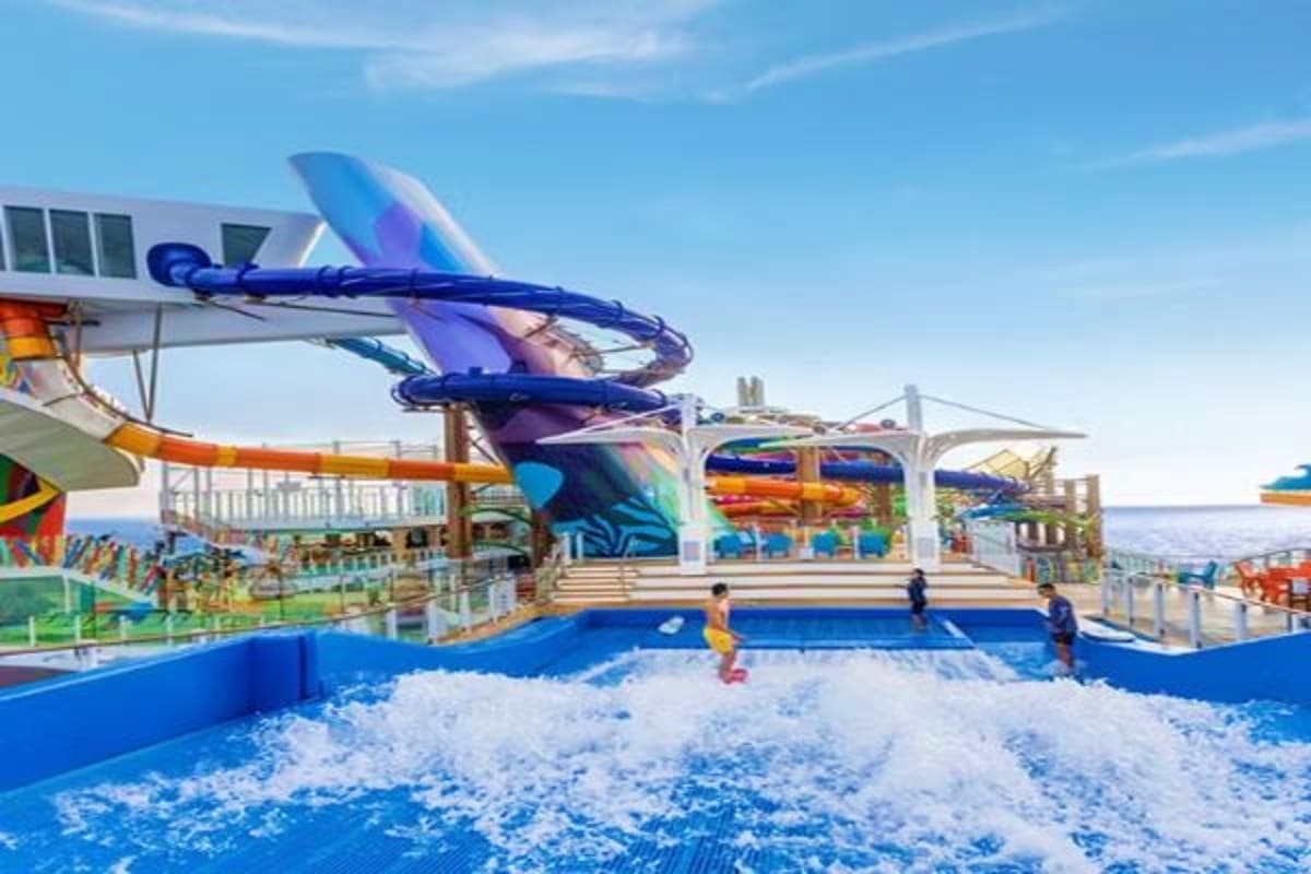 Water slide and wave pool at Legend of the Seas cruise ship with ocean views and clear blue sky