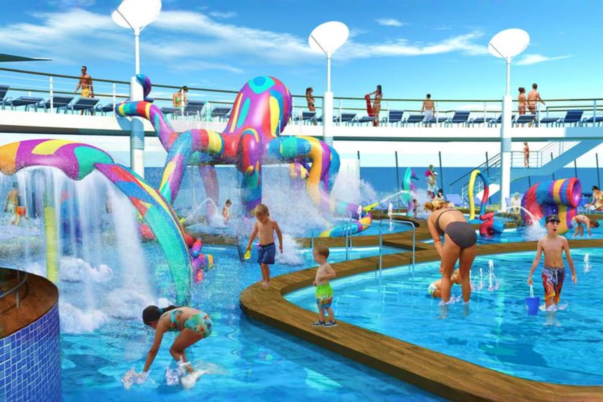 Colorful water park with rainbow inflatable octopus slides and children playing in pools on a cruise ship deck under blue sky