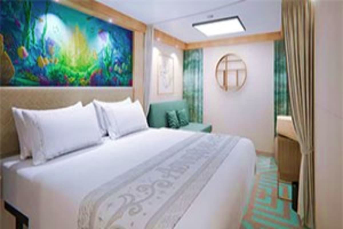 Modern cruise ship stateroom with white bedding, teal accents, ocean-themed artwork, and round mirror
