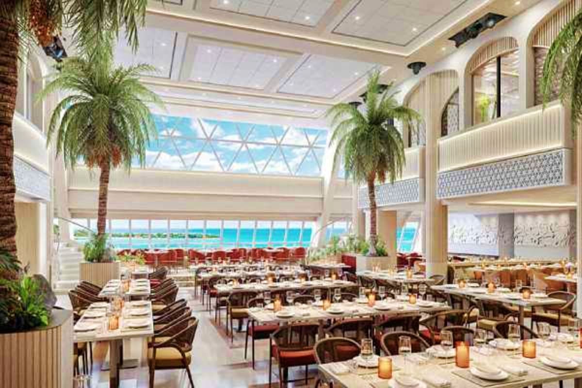 Luxury dining room on Aroya cruise ship with floor-to-ceiling windows overlooking turquoise Red Sea waters, palm trees, and o