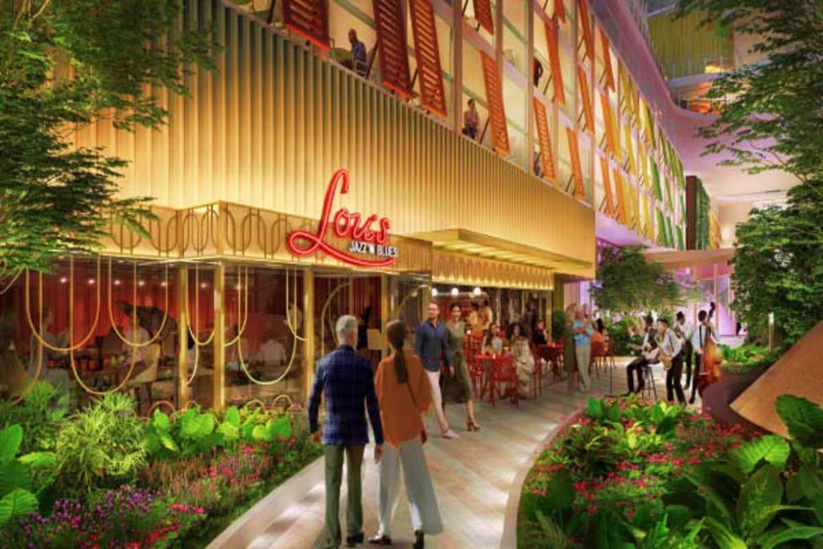 Lola's Jazz Bar neon sign illuminated at night in a modern cruise ship entertainment venue with guests dining and walking thr