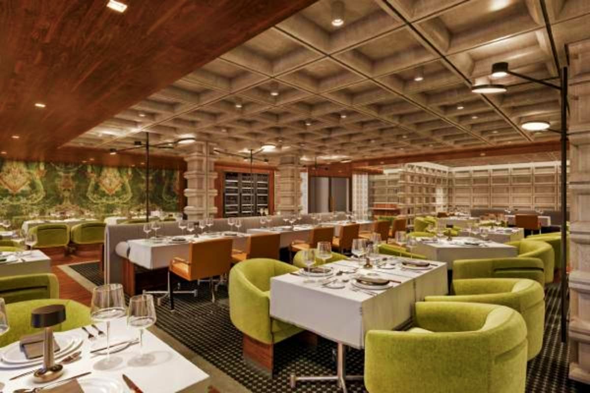 Elegant cruise ship dining room with green upholstered chairs, white tablecloths, wood paneling, and coffered ceiling lightin
