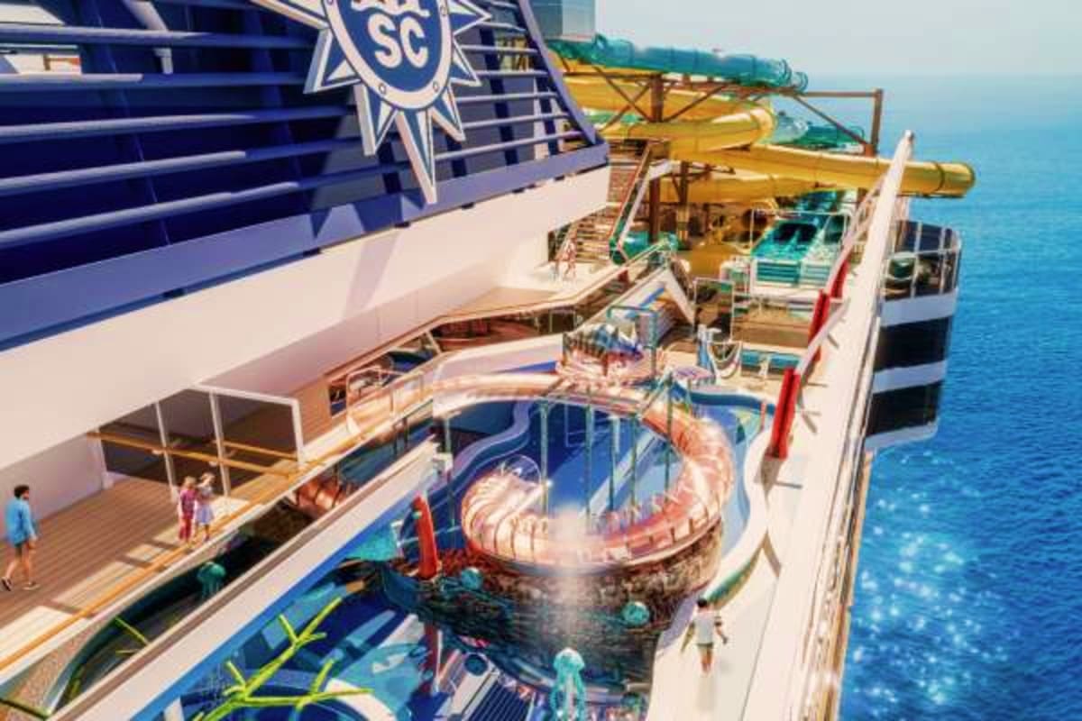 Aerial view of MSC World America cruise ship deck showing water slide, pools, and ocean scenery